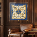 A square silk scarf with a blue and gold nautical design featuring anchors and knots, displayed in a clear acrylic frame on a dark wood-paneled wall in a classic library setting.